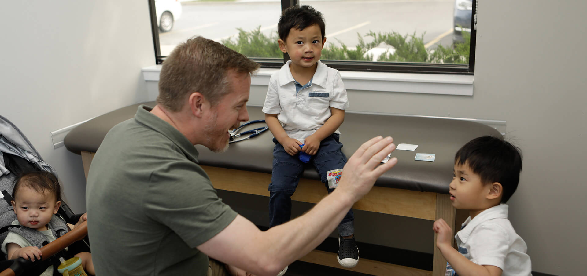 Doctor Playing With Brothers In A Doctor Office