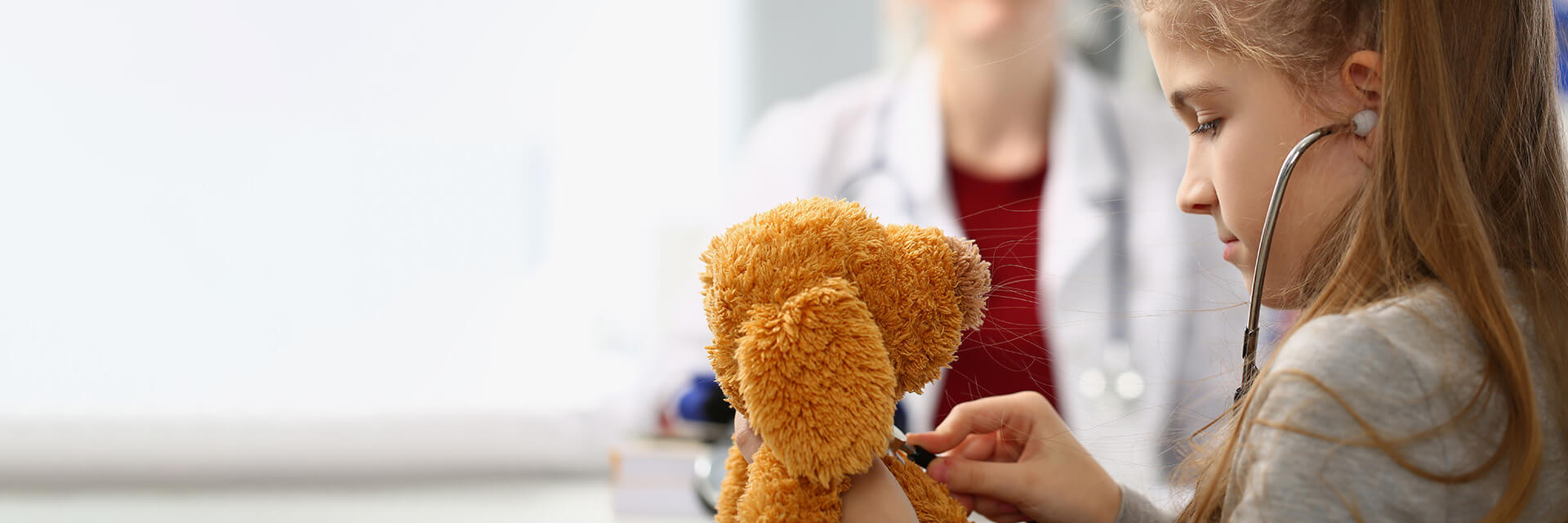 Girl Playing With A Toy And Stethoscope