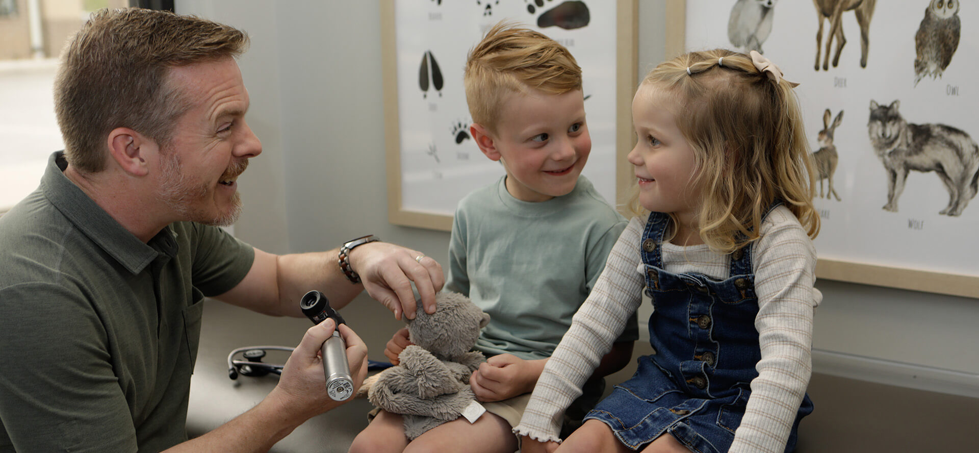 Doctor Examining Toy And Talking To A Little Girl