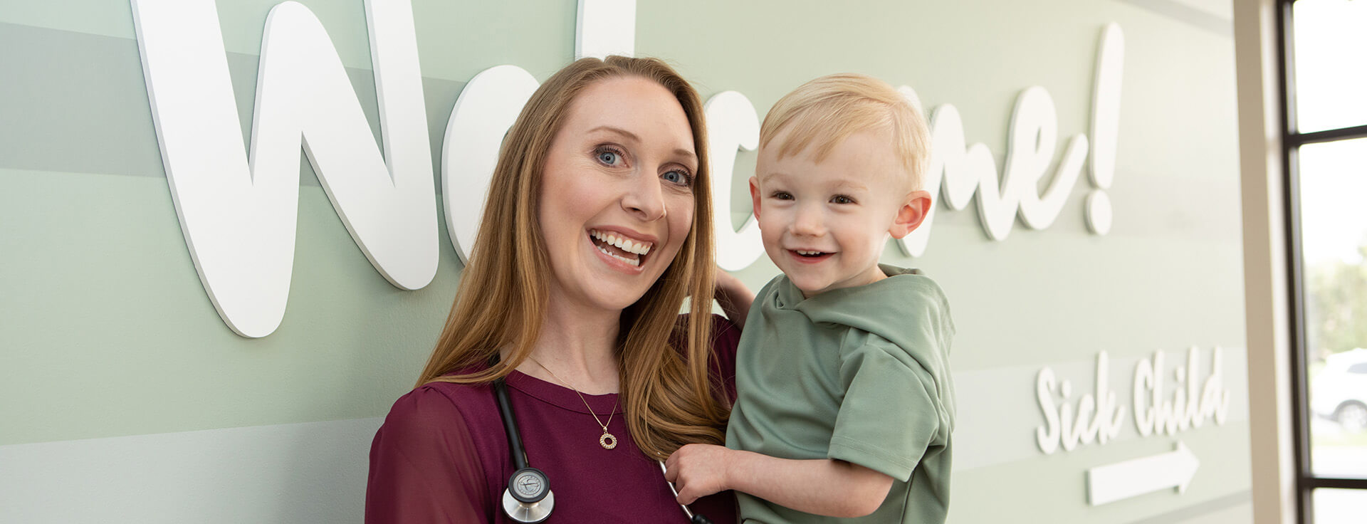 Doctor Holding Toddler In The Hallway